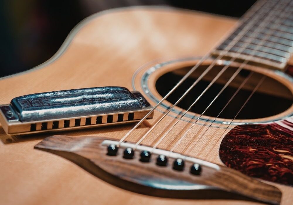 Harmonica sitting on guitar