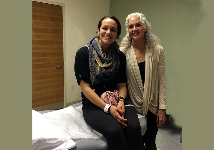 Kayla Redig leans on her mom, Patty Redig, for support during her cancer treatment.