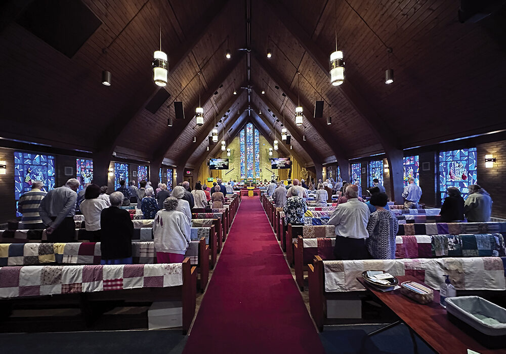 Quilts made by members of the Gloria Dei congregation adorn pews during a worship service before they are donated for distribution across the world. 

Photo courtesy of Gloria Dei Lutheran Church